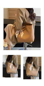 Detail of camel leather tote bag with lychee texture and striped decorative silk scarf