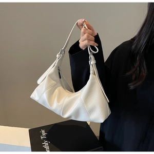 Detail of white pleated oil wax leather shoulder bag with silver metal rings and strap