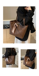 Detail of a brown lychee pattern tote bag with decorative geometric silk scarf accessory