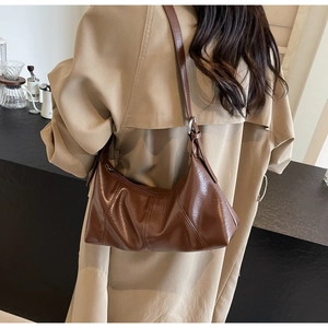 Brown oil wax leather shoulder bag with pleated design and metallic strap buckle