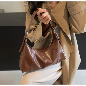 Detail view of brown oil wax leather hobo bag with adjustable strap and silver hardware