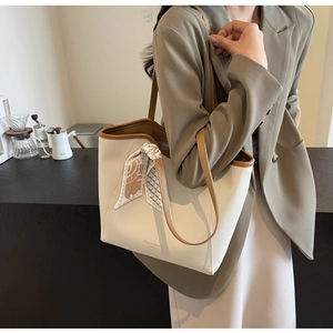 White lychee leather tote bag with brown handles and elegant silk scarf detail