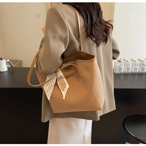 Brown litchi texture tote bag detail with a stylish black and white patterned silk scarf