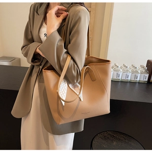 Close-up of camel tote bag with lychee grain texture and Fashion Brand logo detailing