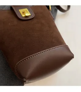 Detailed view of dark brown bucket bag showing suede stitching and fine stitching craftsmanship