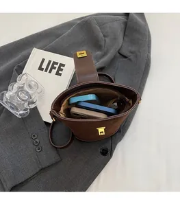 Interior view of brown suede bucket bag showing spacious capacity for smartphones