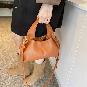 Caramel lychee grain dumpling handbag with plush handle and gold-tone hardware