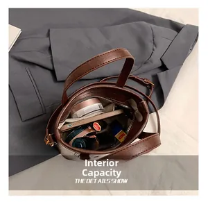 Internal capacity of the brown pebbled leather tote bag showing makeup and smartphone