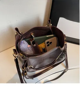 Macro shot of dark brown leather tote interior showing spacious capacity and zipper pocket
