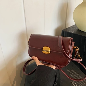Vintage burgundy square crossbody bag with glossy finish and gold metal clasp closure