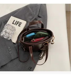 Interior view of brown leather bucket bag showing large capacity for phone and wallet