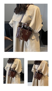 Detail of a vintage dark brown glossy leather bucket bag with braided tassel and gold hardware