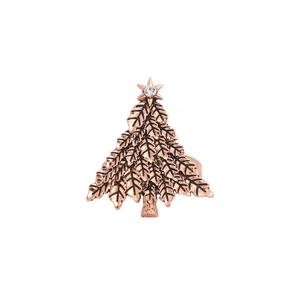 Detailed view of a vintage rose gold Christmas tree napkin ring with rhinestone star