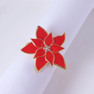 Elegant red flower napkin ring with gold finish and rhinestones on white cloth