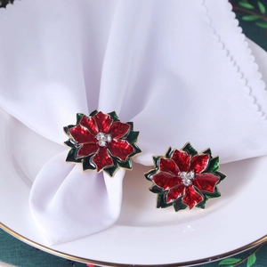 Festive Christmas napkin rings featuring red poinsettia flower and green leaf design