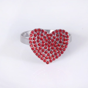 Close-up of heart-shaped napkin ring with sparkling red rhinestones and silver finish