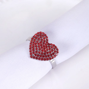 Detail of red crystal heart napkin ring with silver metal finish for elegant table settings