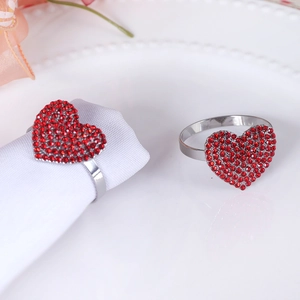 Silver napkin ring with heart-shaped design and sparkling red rhinestones for table decor