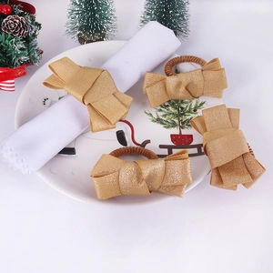 Set of 4 gold fabric bow napkin rings for festive Christmas dining table decoration