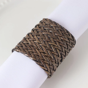 Détail du rond de serviette en cuir tressé marron foncé avec texture tressée précise