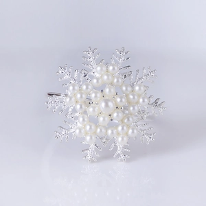 Silver snowflake napkin ring with elegant pearl inlays and a polished metallic finish