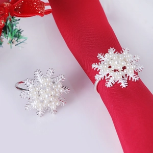 Silver snowflake napkin rings set with faux pearls and festive red fabric wrap