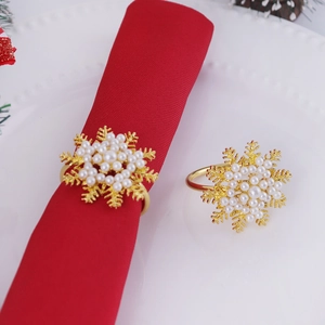 Golden snowflake napkin ring with pearls on red napkin for Christmas table decor