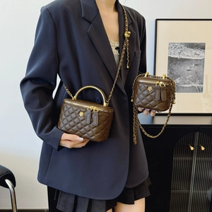 Quilted dark brown bucket bag set with gold chain strap and floral buckle accent