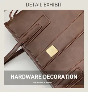 Close-up of brown leather tote bag featuring gold square hardware and fine stitching