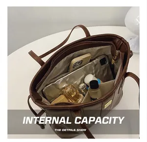 Interior view of brown tote bag showing large capacity with phone and cosmetics