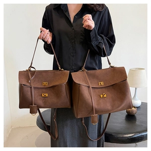 Comparison of large and small retro matte suede handbags with gold metal clasps and straps