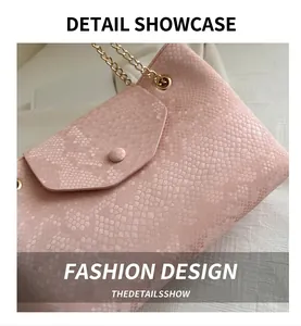 Detail of pink snake-pattern leather handbag with golden chain strap and matching buckle