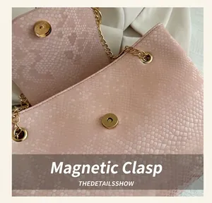 Close-up of pink snake-pattern leather bag with gold chain strap and magnetic snap