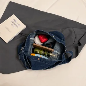 Macro view of interior capacity showing large denim tote with magnetic closure