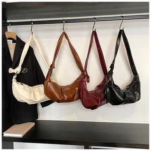 Detailed display of vintage hobo bags in four colors with soft pleated leather and knot straps