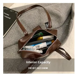 Macro detail of the spacious internal capacity of this dark brown vintage bowling bag