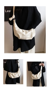 Detail of soft cream hobo bag with unique knot shoulder strap and pleated faux leather