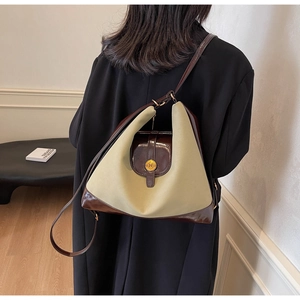 Détail du sac à bandoulière bicolore en toile et cuir avec fermoir doré logo N chic