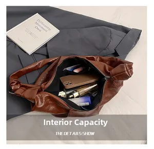 Interior view of brown vintage leather hobo bag showing large capacity and zipper pocket
