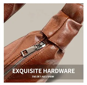 Detail of silver metal zipper closure and stylish knotted shoulder strap on brown bag