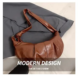 Detailed macro view of the brown wrinkled leather surface and metal ring hardware on the bag