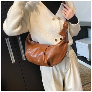 Brown soft faux leather hobo bag with vintage pleats and stylish shoulder strap knot detail