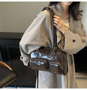 Detail of dark brown vintage bowling bag with dual front zippers and glossy leather finish