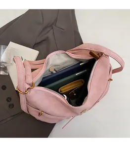 Top view of pink suede shoulder bag interior showing large capacity and zipper pocket