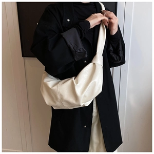 Minimalist cream croissant bag with soft pleated leather and stylish knot detail
