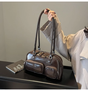 Close-up of vintage brown leather bowling bag with functional multi-pocket zipper detail
