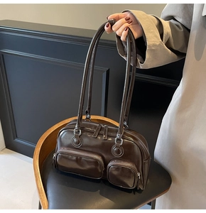 Detail of vintage dark brown faux leather bowling bag with functional zip pockets