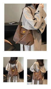 Detail view of large brown leather tote bag with iconic triangle metal plaque and strap
