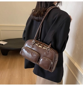 Detail of dark brown vintage bowling bag with dual zipper pockets and glossy oil wax finish