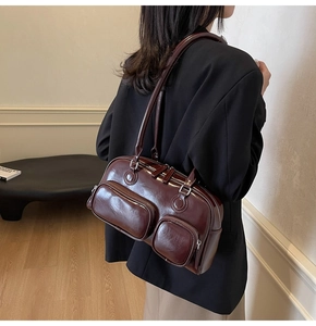 Detail view of a vintage dark brown oil wax leather bowling bag with functional pockets